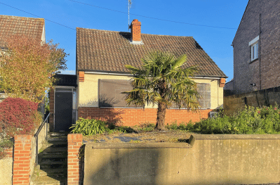 Front view of a derelict bungalow 