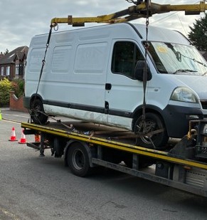 A white van being seized for having no insurance and other traffic offences.