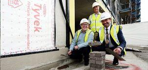 Preparing the first brick to be laid