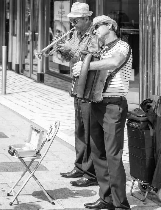 Two buskers standing with instruments 