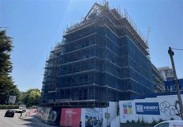 View of the development which shows the scaffolding and hoarding on site