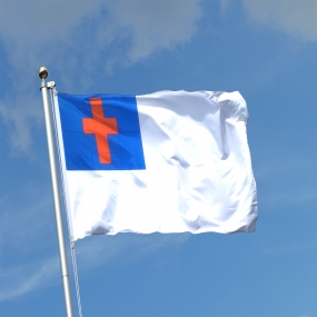 Christian flag flying high with blue sky in background.