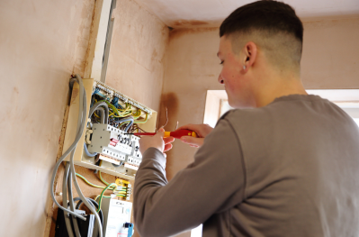 Engineer working on an electrical mains board