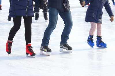 3 people ice skates one ice
