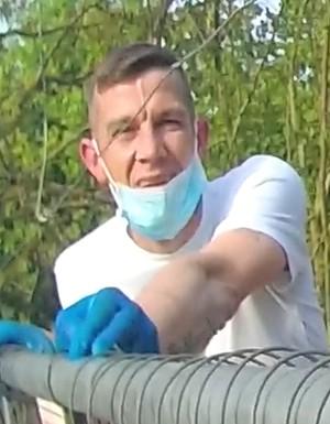 Jamie broadmore wearing white tshirt, blue gloves and a face mask