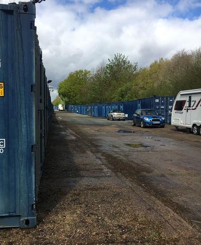 Land being unlawfully used for storage of blue shipping containers