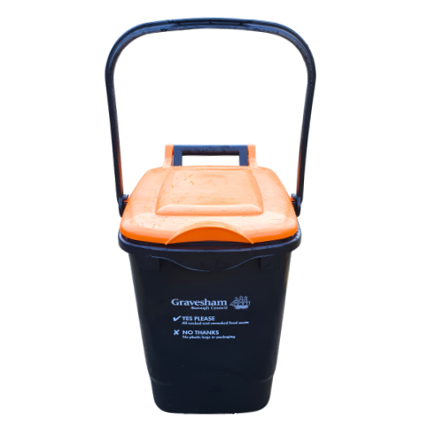 Black caddy bin with orange lid and upright handle. Bin has Gravesham Borough Council logo and tick yes please to food waste. Cross no thanks to rubbish.