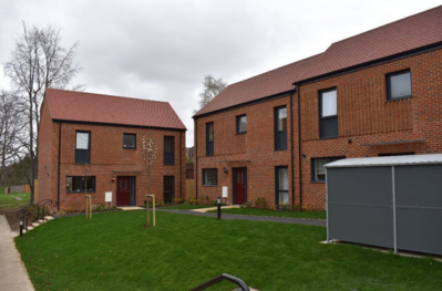 View of housing development Pankhurst place and green grass in front.