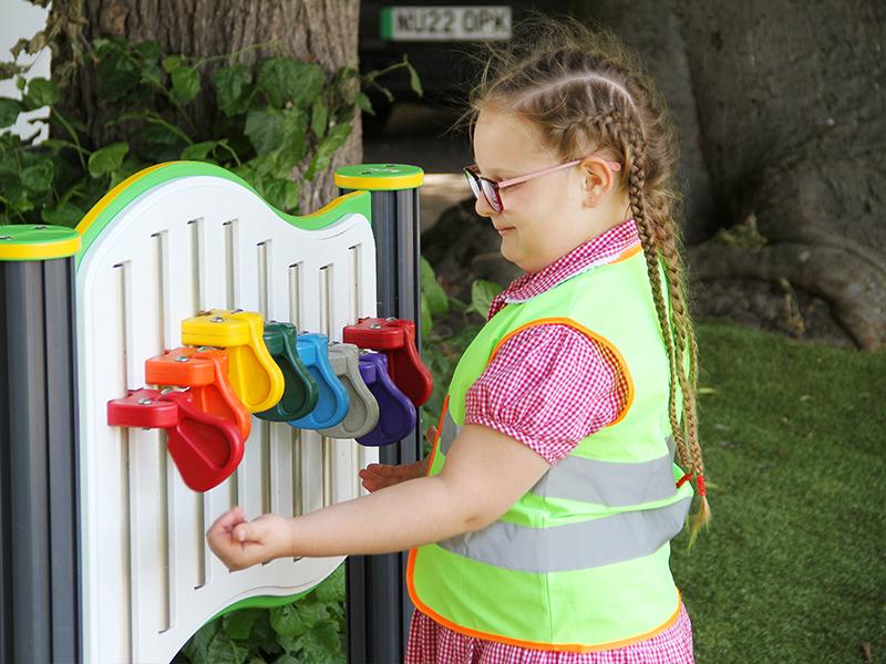 Student trying out sensory musical instruments