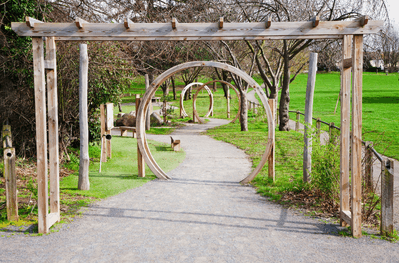 Looking down the new pathway with wooden pergola and archways leading down a path to a garden