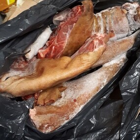pieces of frozen smokie meat in a black bag
