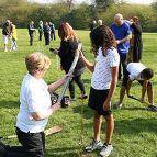 Two people planting a tree in a park