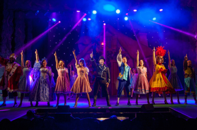 Photo from Woodville theatre stage showing pantomime performance with bright colourful lights for a finale