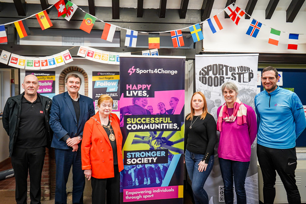 Opening ceremony with representatives from Sports 4 Change and Gravesham Borough Council, standing in front of a sign for Sports4Change.