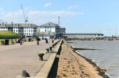 View of the promende riverside area gravesend showing the water to the right and the pier in the distance